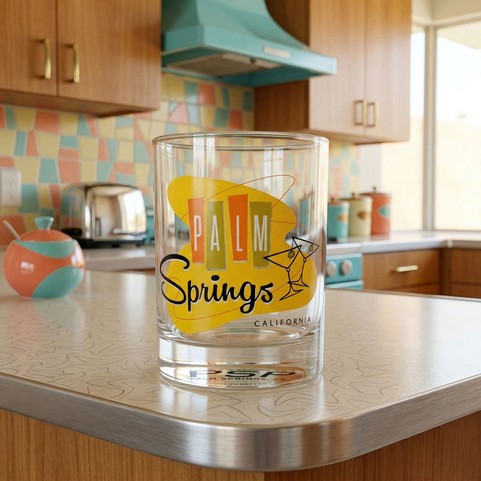 Clear glass with 'Palm Springs, California' design on a kitchen counter