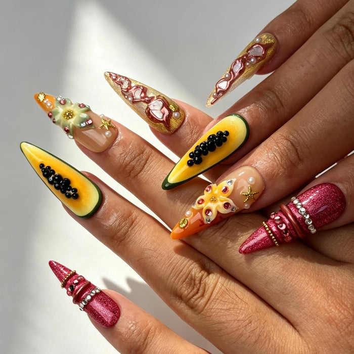 Vibrant papaya orange floral long stiletto press‑on nails on hand