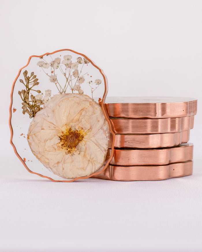 Tall portrait photo of a pressed flower geode coaster with mixed dried blooms and clear edge