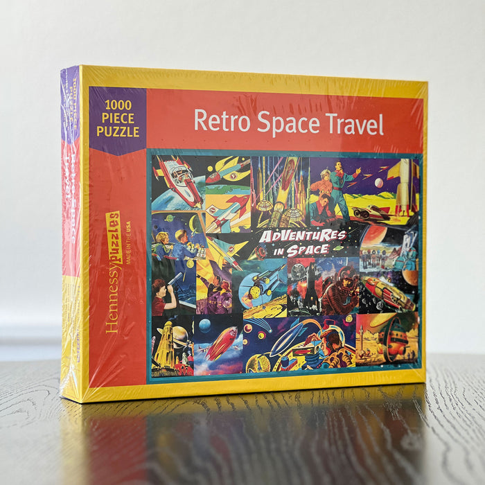 Puzzle box titled 'Retro Space Travel' with colorful space-themed design on a wooden surface.