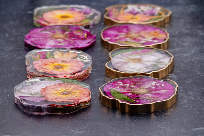 Round Ottoman Tray & Geode Coaster Bundle featuring vibrant preserved flower coasters in resin.