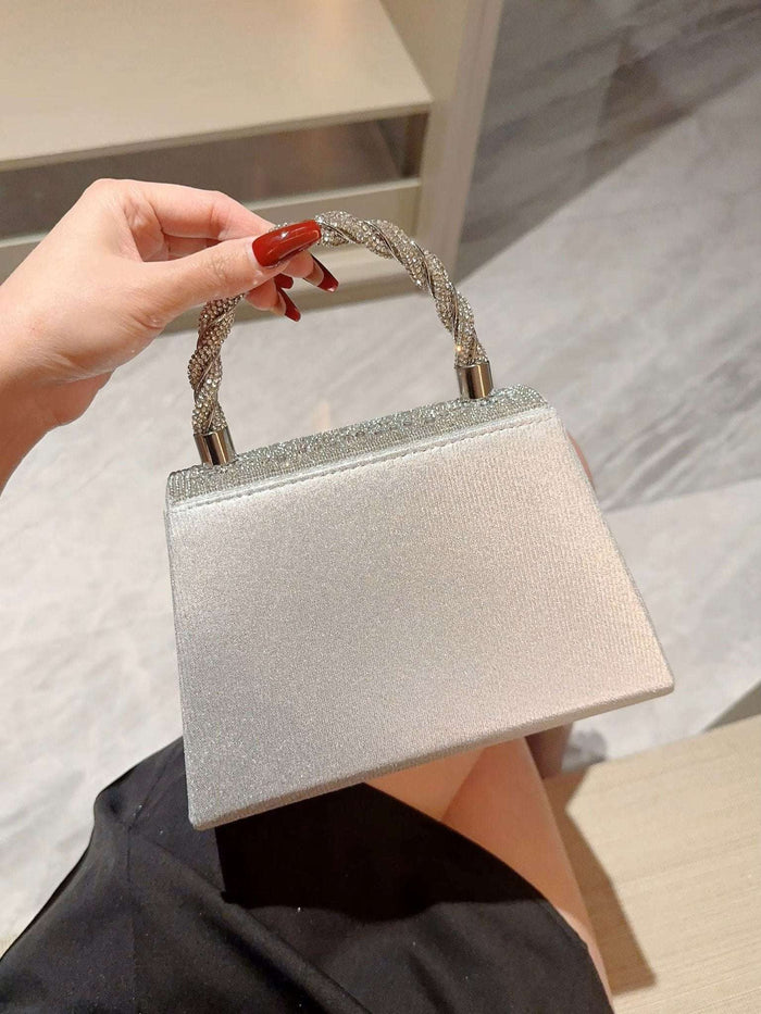Silver Crystal studded clutch Bag with Rope Handle featuring a shimmering textured finish and braided crystal rope handle, perfect for evening wear.