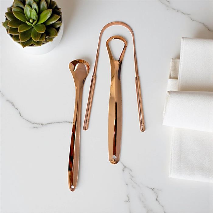 Rose gold 3-piece stainless steel tongue scraper set by LaserGlow shown with travel case for fresh breath and daily oral care
