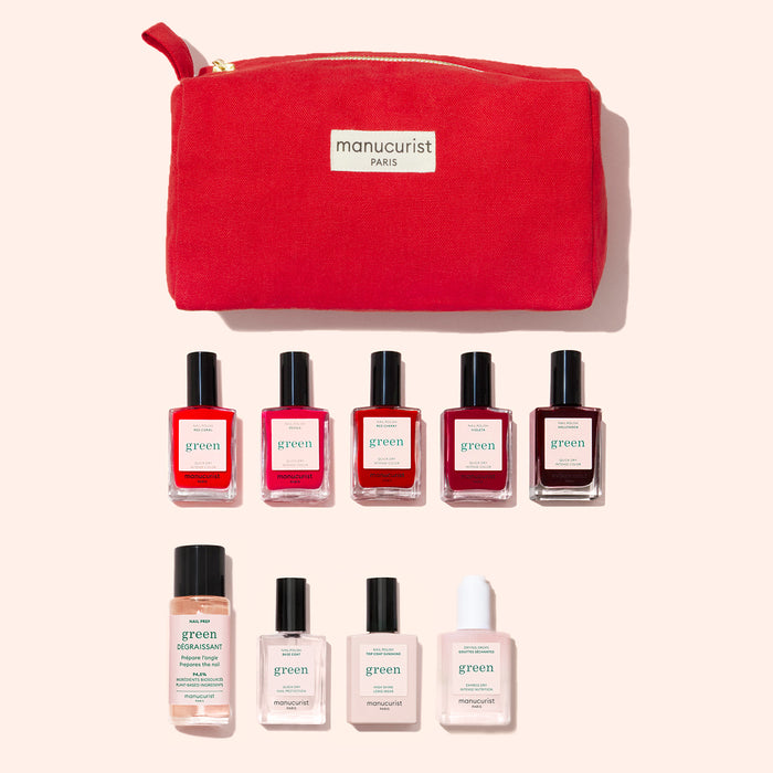The Manucurist Super Starter Kit includes a red pouch labeled "manucurist PARIS" with nine nail care bottles—plant-based polishes in reds and pinks plus remover, base coat, and top coat—ideal for a Green manicure.