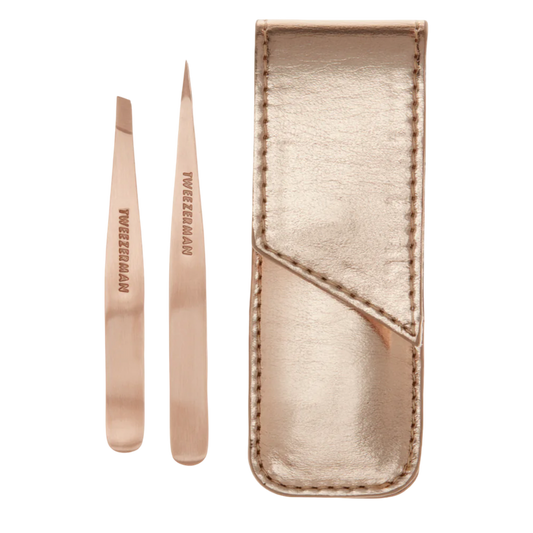 Rose gold tweezers with a matching case on a white background