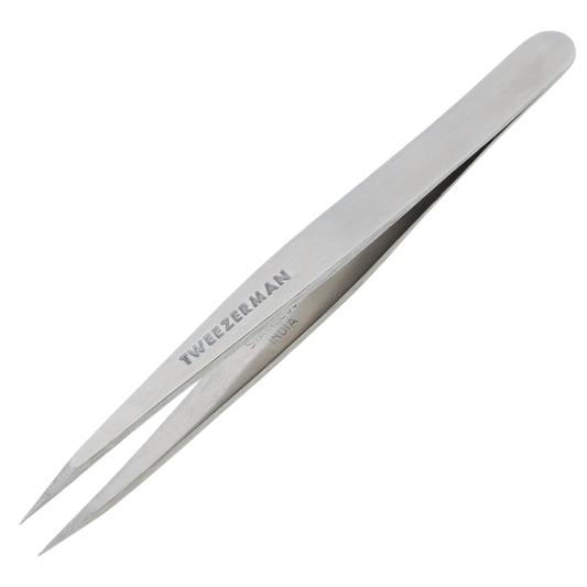 Metallic tweezers with 'Tweezeerman' branding on a white background