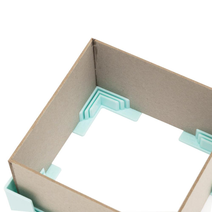 We R Memory - Corner Guides - 4/Pkg. Great for boxes, book covers, dioramas, and more! Holds corners tightly while adhesive sets. Works with 3mm, 2mm, 1.5mm, and 1mm wide chipboard. Imported. Available at Embellish Away located in Bowmanville Ontario Canada.