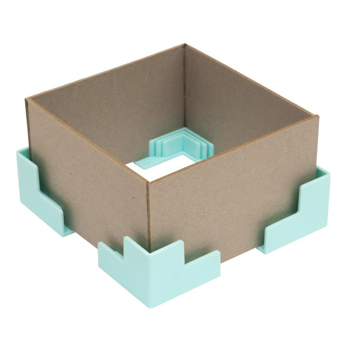 We R Memory - Corner Guides - 4/Pkg. Great for boxes, book covers, dioramas, and more! Holds corners tightly while adhesive sets. Works with 3mm, 2mm, 1.5mm, and 1mm wide chipboard. Imported. Available at Embellish Away located in Bowmanville Ontario Canada.